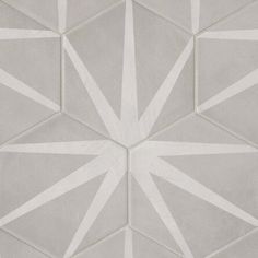 a white and gray tile wall with geometric shapes