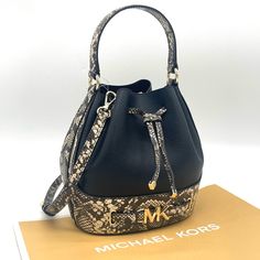 Brand New With Tag Michael Kors Reed Medium Belted Bucket Messenger Crossbody Bag Details Color: Nat/Black Bucket Bag Denim Color Pebbled Leather 100% Leather Trim: 60% Polyurethane/20% Cotton/ 20% Polyester Gold-Tone Hardware 9.25'w 8.5"H 5.5"D Handle Drop: 4.5" Adjustable Strap: 18"-21.75" Interior Details: Back Slip Pocket Lining: 100% Polyester Drawstring Fastening Imported Designer Black Bucket Bag For Errands, Black Bucket Bag With Branded Hardware For Daily Use, Luxury Michael Kors Bucket Bag For Travel, Michael Kors Crossbody Bucket Bag For Travel, Michael Kors Bucket Bag With Detachable Strap For Shopping, Chic Michael Kors Bucket Bag For Daily Use, Luxury Michael Kors Bucket Bag With Detachable Strap, Michael Kors Bucket Shoulder Bag With Detachable Strap, Black Michael Kors Bag With Dust Bag Included