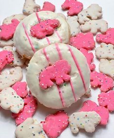 some pink and white cookies with icing on them