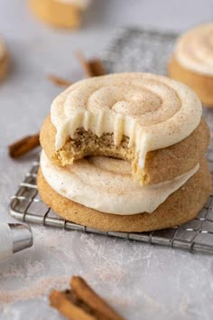 two cinnamon roll cookies on a cooling rack