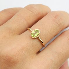 14k solid gold ring featuring ethically sourced genuine peridot size 6x4mm. Peridot is the birthstone for the month of August. Will make a great birthday gift and also a unique engagement ring for women who want something bit different from the ordinary diamond engagement ring. This antique-inspired ring has leaf gallery design on setting allowing more lights to go through the stone to maximize the brilliance of the stone. The band is tapered to give a delicate look yet being sturdy. * Peridot s Gold Peridot Ring, Oval Stone Ring, Minimalist Engagement Ring, Platinum Rose Gold, Vintage Style Earrings, Mens Chain Necklace, August Birthstone, Gallery Design, Peridot Ring