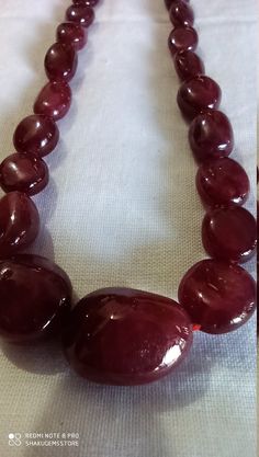 Awesome 398 Carat Fine Quality Natural Ruby Plain 21 Inch Necklace Adjustable code Stone :Natural Ruby Shape :- fancy oval Necklace - 21 inch 1 line string Size :- 5x7mm to 21x15mm Weight :- 398 carat Polish :- Handmade Purity :- 100% Natural Gemstone color - red makes a great gift for your loved ones. It is known as the 'love stone' as the message it emits is the strong vibration of unconditional love, joy, warmth and healing. As quartz crystals are profound amplifiers of energy, it may help to Elegant Round Amber Beads, Gems, And Cabochons, Elegant Amber Beads, Gems, And Cabochons, Polished Beads For Formal Gems And Cabochons, Elegant Round Amber Beads And Cabochons, Elegant Oval Natural Gemstones, Formal Oval Necklace With Large Stone, Oval Gemstone Beads Necklaces For Formal Occasions, Formal Oval Gemstone Beads Necklace, Oval Amber Necklace With Natural Stones