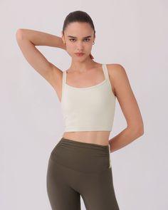 The SARA TOP in BONE by Nylora is a classic tank top made with their signature 4-way stretch rib fabric. Featuring an open back detail and a built-in shelf bra with removable padding, this top offers both style and functionality. Perfect for any active lifestyle, this top provides comfortable support and a flattering fit. DETAILS: Open back detail top Nylora's signature 4-way stretch rib fabric Built-in shelf bra with removable padding 77% Nylon, 23% Spandex Machine wash SIZE & FIT: Fits true to Athleisure Crop Top With Adjustable Straps For Yoga, Sports Tank Top With Built-in Bra And Minimal Stretch, Sporty Top With Adjustable Straps And Strappy Back, Sporty Tops With Adjustable Straps And Strappy Back, High Stretch Athleisure Tank Top With Adjustable Straps, Yoga Tank Top Bra Friendly Minimal Stretch, Athleisure Sports Tank Top With Removable Bra Pads, Athleisure Crop Top With Adjustable Straps, Athleisure Tank Top With Removable Bra Pads For Gym