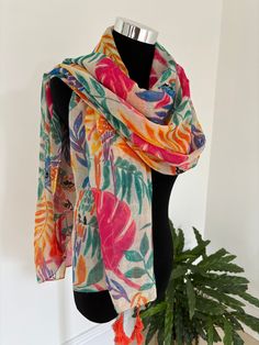 Experience the epitome of comfort and style with our luxurious multi-colored scarf, adorned with vibrant flower and parrot motifs. Crafted from the softest, high-quality fabric, this scarf provides a cozy feel against your skin. The lively design adds a touch of elegance and whimsy to any outfit, making it a versatile accessory for any occasion. Whether you're dressing up for a special event or adding a pop of color to your everyday ensemble, this scarf is the perfect choice. Enjoy the blend of Casual Multicolor Shawl For Spring, Multicolor Beach Shawl For Spring, Spring Beach Shawl In Multicolor, Casual Multicolor Summer Shawl, Bohemian Multicolor Scarves, Multicolor Summer Shawl Scarf, Multicolor Shawl Scarf For Summer, Floral Print Shawl Scarf One Size, Multicolor Silk Shawl For Spring