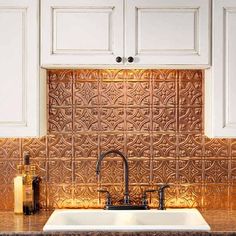 a white kitchen sink sitting under a faucet next to a wooden counter top