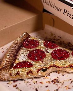 there is a pizza in the box with red toppings and sprinkles