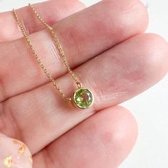 The summer tones of peridot are wrapped in this gold bezel birthstone pendant necklace14K Yellow GoldPeridot 0.36ctLobster clasp Fine Jewelry Lime Green Birthstone, Round Peridot Birthstone Necklace, Green Necklace With Bezel Setting For May Birthstone, Green Gemstone Round Birthstone Necklace, Green Round Gemstone Birthstone Necklace, Green Peridot Necklace In Fine Jewelry Style, Lime Green Peridot Necklace For May Birthstone, Anniversary Peridot Birthstone Necklace, Green Round Birthstone Necklace In Fine Jewelry Style