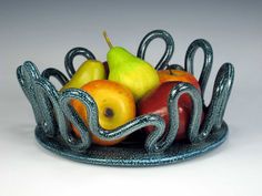 a glass bowl filled with different types of fruit