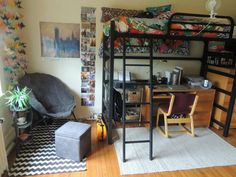 a bedroom with bunk beds, desk and chair next to a rug on the floor