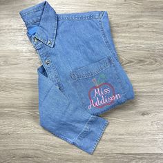 This Personalized Teacher Denim Shirt is a fun and unique way show your love for teaching! Due to the placement of the embroidery, the POCKET IS SEWN CLOSED Personalization is easy!: -Enter Name -Choose Font (Photo 3) -Choose Thread Color (Photo 4) -Done! This Denim Shirt Features: -100% cotton denim -Left-chest pocket -Khaki double-needle topstitching Teacher shirt, shirt jacket, shacket, personalized shirt, denim shirt, gift for teacher Casual Long Sleeve Shirt For End Of School Year, Casual Cotton Shirt For School Events, Police Photo, Jean Jean, Teacher Apple, Color Photo, Gift Teacher, Button Shirt, Personalized Shirts