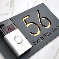 a black and gold sign with the number fifty five on it's front cover