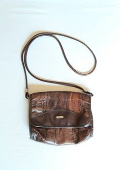 "Vtg leather and vegan leather (mixed materials) cognac brown patches 80s bag. Shoulder bag, crossbody purse. Patched adventure flap bag. The interior not lined, but inside are textile as leather bottom base. With 2 compartments and 1 zippered compartment inside. condition: Good vintage condition. No damages. The closure and zippers works well. Measures: Width 19 cm/ 7.4\" in Height 17,5 cm/ 6.8\" in strap length 119 cm / 46.4\" in" Boho Leather Bags, Hipster Bag, Real Leather Bags, Brown Leather Crossbody Bag, Women Purse, Brown Leather Handbags, Vintage Leather Bag, Brown Leather Bag, Brown Handbag