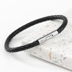 If you're looking for some sleek and stylish men's jewellery for a fashion conscious guy, you're in luck! Our head turning Personalised Men's Infinity Capsule Leather Bracelet is sure to become a firm favourite for him, wearing it out with pride, whatever the occasion! Whether you gift it for his birthday, Christmas or any other special occasion, the lucky recipient will be over the moon with the thought and love behind this exquisite present.   At the heart of the bracelet lies an immaculately Adjustable Braided Bracelet With Stainless Steel Clasp, Masculine Leather Bracelet With Stainless Steel Clasp, Masculine Leather Bracelet For Everyday, Modern Leather Bracelet For Everyday And Father's Day, Masculine Leather Bracelet With Black Band, Extraordinary Moments, Infinity Symbol, Over The Moon, Wedding Bracelet