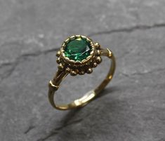 Gold Emerald Ring set with a Created Emerald in a perfect diamond cut, flawless clarity & deep green color, at 8mm diameter, weighting 2 Carats. Round Vintage Ring design made of Gold Vermeil ☞ thickest 18k Gold Plating on top of Solid 925 Sterling Silver ☞ made to last.☞ Choose your size ☞ I resize (before shipping) for FREE to Any size*Matching Earrings: www.etsy.com/listing/1056117887Matching Pendant - please ask me⌛Last Ring left ⌛ Details : ♥ Each item comes in a cute GIFT BOX ✓♥ GUARAN Green Bezel Set Rings For May Birthstone, Green Ring With Center Stone For Proposal, Green Rings With Bezel Setting For May Birthstone, Vintage Green Diamond Ring Gift, Vintage Green Jewelry With Halo Setting, Green Emerald Crystal Ring, Heirloom Green Ring For May Birthstone, Heirloom Green Birthstone Ring For May, Heirloom Green May Birthstone Ring