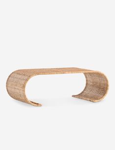 the curved table is made out of wicker and has a wooden base with an open end