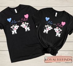 two black shirts with pink and blue hearts on them, one has a cow in the middle