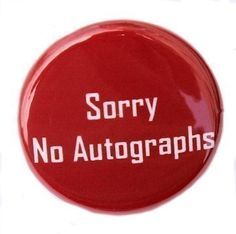 a red button with the words sorry no autographs written in white letters on it