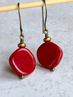 "deep red czech glass earrings boho dangle earrings for women These round-ish, opaque deep red discs are Czech glass beads. Sitting on top is a small, matte gold glass disc. Hook ear wires are antiqued brass. Length of earrings from top of ear wires is 1 1/2\". Red discs measure about 15mm, just over 1/2\". You can enter my shop here: gypsydangles.etsy.com" Aqua Glass, Leverback Earrings, Bohemian Earrings, Exeter, Purple Glass, Gold Glass, Earrings Boho, Brass Earrings, Bead Earrings