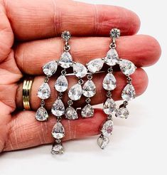 Gorgeous long vintage sparkly Austrian crystal drop dangle earrings. Rhodium plated metal set with best quality sparkling pear shaped Austrian crystals. Posts for pierced ears. The backs are new backs I added to the earrings. Excellent vintage condition with minimal age appropriate wear. Measure 2 3/8 inches long by 1 inch wide. Dazzling Crystal Drop Chandelier Earrings, Crystal Teardrop Dangle Earrings With Sparkling Stones, Rhinestone Dangle Chandelier Earrings For Anniversary, Silver Teardrop Chandelier Earrings With Sparkling Stones, Crystal Pear-shaped Chandelier Earrings For Parties, Crystal Drop Chandelier Earrings With Sparkling Stones, Pear-shaped Silver Crystal Earrings, Cubic Zirconia Dangle Teardrop Earrings With Rhinestones, Rhinestone Teardrop Dangle Earrings In Cubic Zirconia