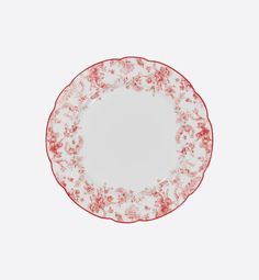 a red and white plate sitting on top of a table