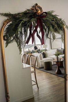 a mirror reflecting a living room with christmas decorations