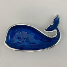 a brooch with a blue whale design on it