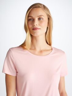 Our women's pink leisure t-shirt is an effortlessly chic sport-luxe essential. The Lara fabric is a slightly lighter weight than Basel but has enough coverage to be worn out of the house and also offers good breathability, making it perfect for warmer climates. Not only is the Lara versatile, it has maintained the super-soft fabric quality and stretch composition that we know you love. What's more, the Lara fabric retains its initial softness and colour and is also responsibly and ethically sourced; spun and knitted in Europe. To make it truly special, we can personalise your garment with initials or a motif. Read more about our personalised services here. The model is 5’10” / 178cm tall with waist size 25” / 63cm, bust size 32” / 82cm. She wears a size Small. Everyday Feminine Pink Tops, Feminine Pink Everyday Tops, Feminine Everyday Pink Tops, Classic Pink T-shirt For Summer, Feminine Crew Neck T-shirt, Classic Pink Tops For Everyday, Classic Pink Everyday Tops, Classic Pink Relaxed Fit Top, Pink Scoop Neck Athleisure Top