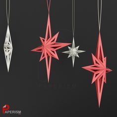 three origami stars hanging from strings on a black background with the word paperism written below them