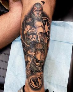 a man's leg with a star wars tattoo on it and the image of boba fett