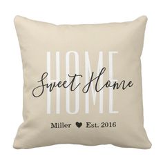 a white pillow with the words home on it and a heart in black ink that reads,