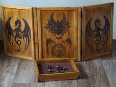 three wooden boxes with dices in them sitting on the floor next to each other