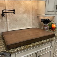 a kitchen counter with a cutting board on it