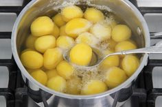 a pot filled with lots of yellow balls