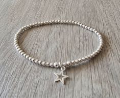 Sterling silver beaded stretch bracelet with an open star charm. This bracelet is made with 3mm sterling silver beads restrung onto quality beading elastic, with an 10mm t open star suspended from the centre.  A simple but stunning bracelet which can be worn on its own or stacked with other bracelets. This bracelet is available in different lengths please choose your size from the drop down list. This bracelet is made to order especially for you with the choice of arriving in an organza bag or g Jewellery Nails, Vision Bored, Silver Beaded Bracelet, Beaded Stretch Bracelet, Star Charms, Pretty Jewellery, Bracelet Stack, Sterling Silver Bead, Bead Bracelet