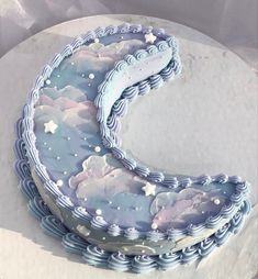 the cake is decorated with clouds and stars