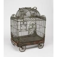 an antique bird cage with wheels and birds in it on a white background, there is no image here to provide a caption for