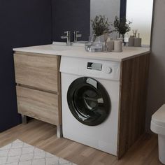 a washer sitting in front of a bathroom sink