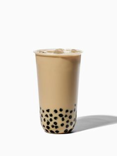 a coffee cup with black spots on the bottom and white inside, sitting in front of a white background