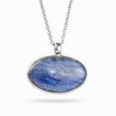 A rich blue stone with natural color banding and depth, this blue beauty will compliment any look. Kyanite is one of the few minerals that never need cleansing or clearing, as it does not retain any negative energy or vibrations. Wearing this gemstone aligns all chakras, bringing you tranquility and a calming effect to one's whole being. It is the perfect stone to facilitate meditation. Stone Origin: BrazilPlease Note: All pieces shipped within 48 hours from our Del Mar Gallery Measures Approxim Sterling Silver Necklace With Large Oval Stone, Oval Sterling Silver Necklace With Large Stone, Spiritual Oval Necklace With Polished Finish, Oval Sterling Silver Necklace With Cabochon, Spiritual Sterling Silver Oval Necklace, Sterling Silver Oval Pendant Necklace With Cabochon, Spiritual Oval Cabochon Gemstone Necklaces, Sterling Silver Cabochon Oval Pendant Necklace, Spiritual Oval Cabochon Necklace