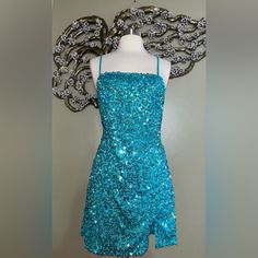 a mannequin wearing a blue sequined dress