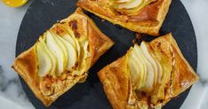 four pieces of apple pie on a black plate