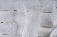 several white towels stacked on top of each other