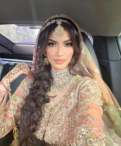 a woman in a car wearing a bridal outfit