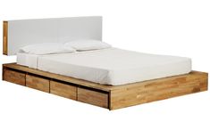 a bed with two drawers underneath it and a white sheet on the bottom shelf next to it