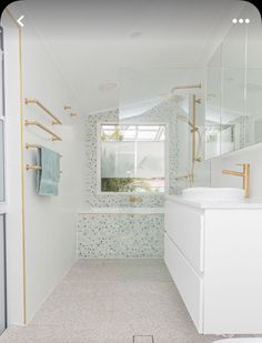 a bathroom with a sink, toilet and shower in it's own area is shown