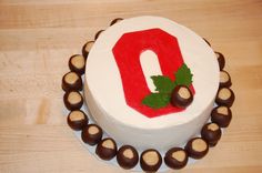 there is a cake that has chocolates on the bottom and an o on top