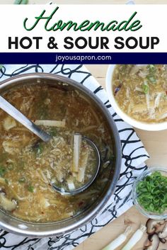 homemade hot and sour soup in a pot with spoons on the side, surrounded by vegetables