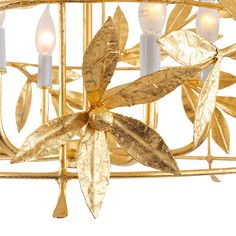 a golden chandelier with four candles and leaves