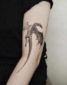 a woman with a dragon tattoo on her arm