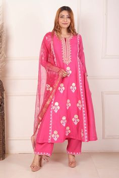 Rani pink chanderi anarkali featuring all over block printed floral motifs highlighted with dori embroidery. Comes with palazzo and dupatta.
Components: 3
Pattern: Block Print, Embroidered
Type Of Work: Floral, Dori
Neckline: Notched
Sleeve Type: Three quarter
Fabric: Anarkali: Chanderi, Palazzo: Cotton, Dupatta: Organza 
Color: Pink
Other Details: 
Length:
Anarkali:  48 Inches
Palazzo: 38 Inches
Dupatta: 2.5 Mtr 
Occasion: Sangeet,Mehendi and Haldi - Aza Fashions Pink Floral Anarkali, Chanderi Anarkali, Floral Anarkali, Dori Embroidery, Pink Anarkali, Rani Pink, Palazzo Set, Cotton Dupatta, Boutique Dress Designs